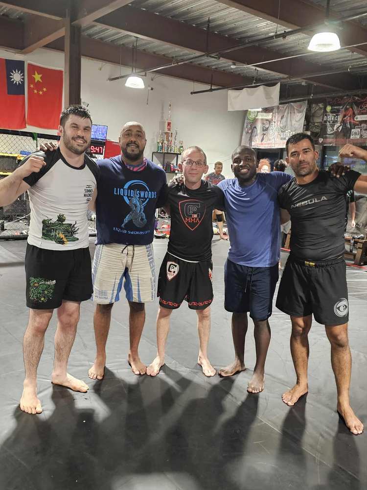 WDC BJJ coaches working with students on the mats in Takoma Park