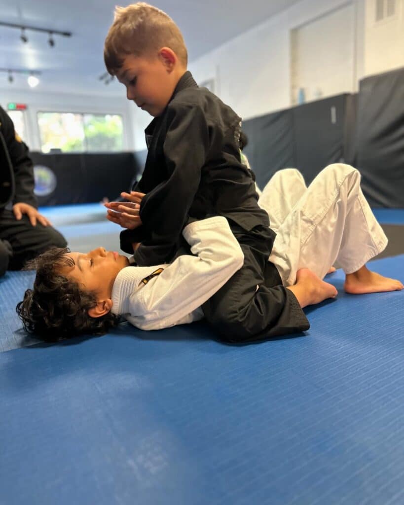 Kids training Brazilian jiu-jitsu on the mats at WDC BJJ summer camp